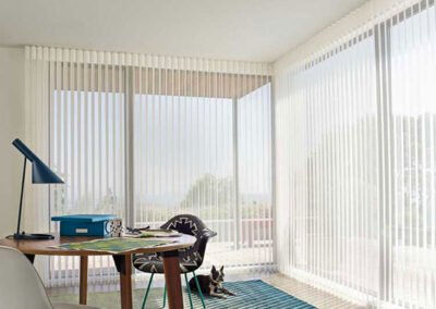 tall vertical blinds in corner office nook with large windows