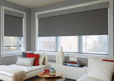 charcoal roller shades in room nook with colorful doodads