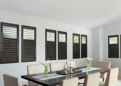 Dark dining room shutters by Camelot Interiors