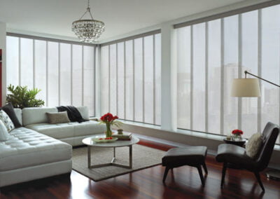 Skyline panel window coverings in large lofty living room