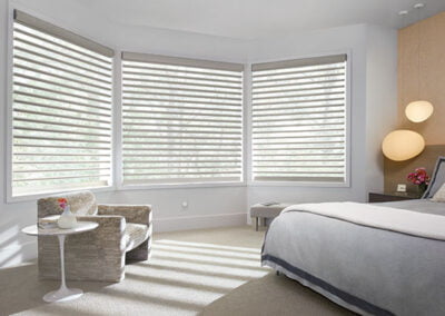 beautiful bedroom window fitted with hunter douglas pirouette shades